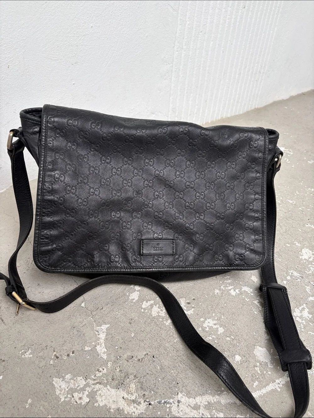 Gucci Guccissima black leather messenger bag